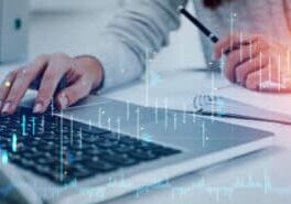 Office woman fingers typing on laptop. Double exposure with stock market forex dynamics, candlesticks and notebook on the table. Concept of online trading